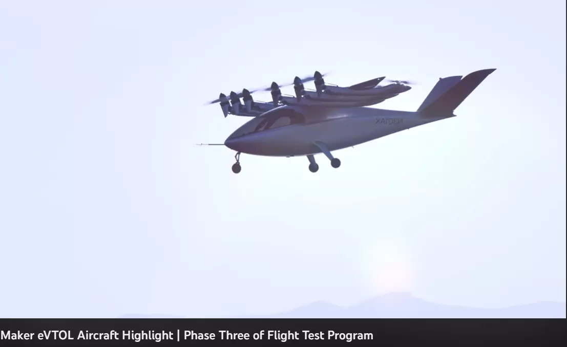 A plane with a group of small drones on top of it Description automatically generated